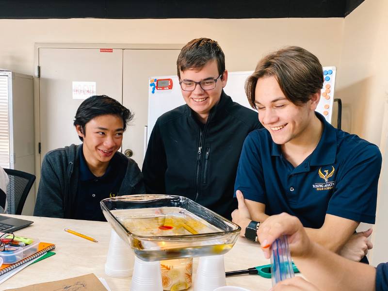 private high school students doing experiments in class